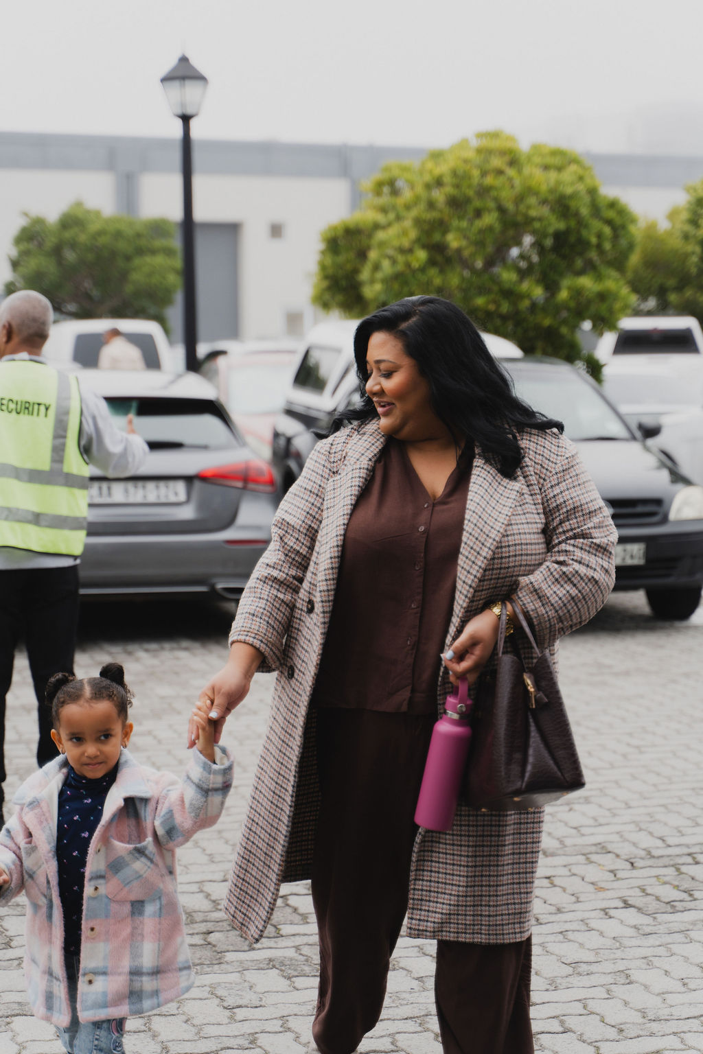 Mother walking into church holding child